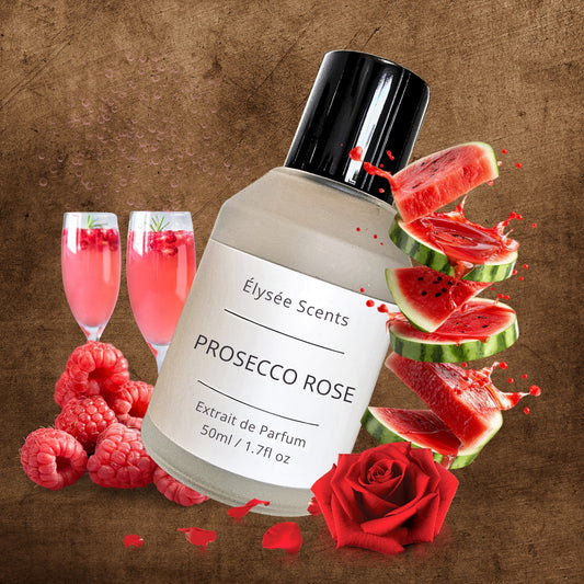 Bottle of Elysee Scents Prosecco Rose perfume with watermelon, raspberries, and champagne glasses on a brown background