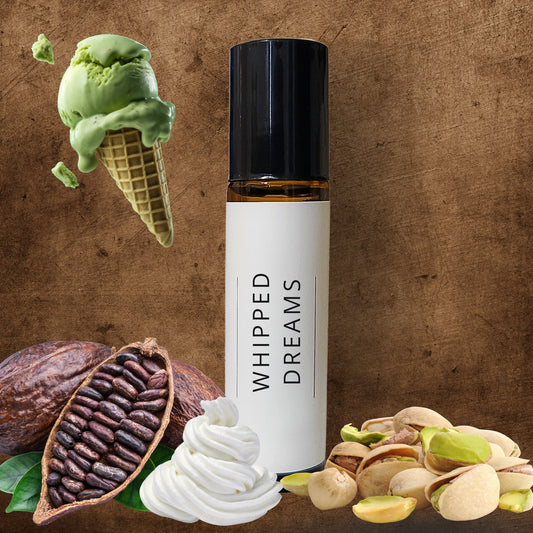 10ml Roller bottle labeled 'Whipped Dreams' surrounded by green ice cream, pistachios, and cacao beans on a brown background.